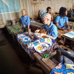 Africa Surgery is providing sewing machines and other supplies, and pays the registration fee for disabled students. Among them, we have two young ladies affected by albinism, a disability in Sierra Leone. The intense West African sun causes many victims of albinism to develop skin lesions which can turn into skin cancer and painfully shorten their lives.